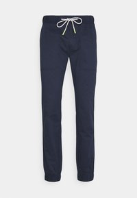Námořnické modré jogger kalhoty s elastickým pasem, šňůrkou s neonovými akcenty a elastickými manžetami. Mají boční kapsy a hladký povrch.