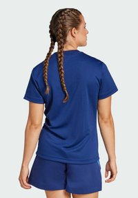 Navy blue athletic t-shirt with a relaxed fit and short sleeves, paired with navy shorts. Fabric appears smooth with subtle texture.