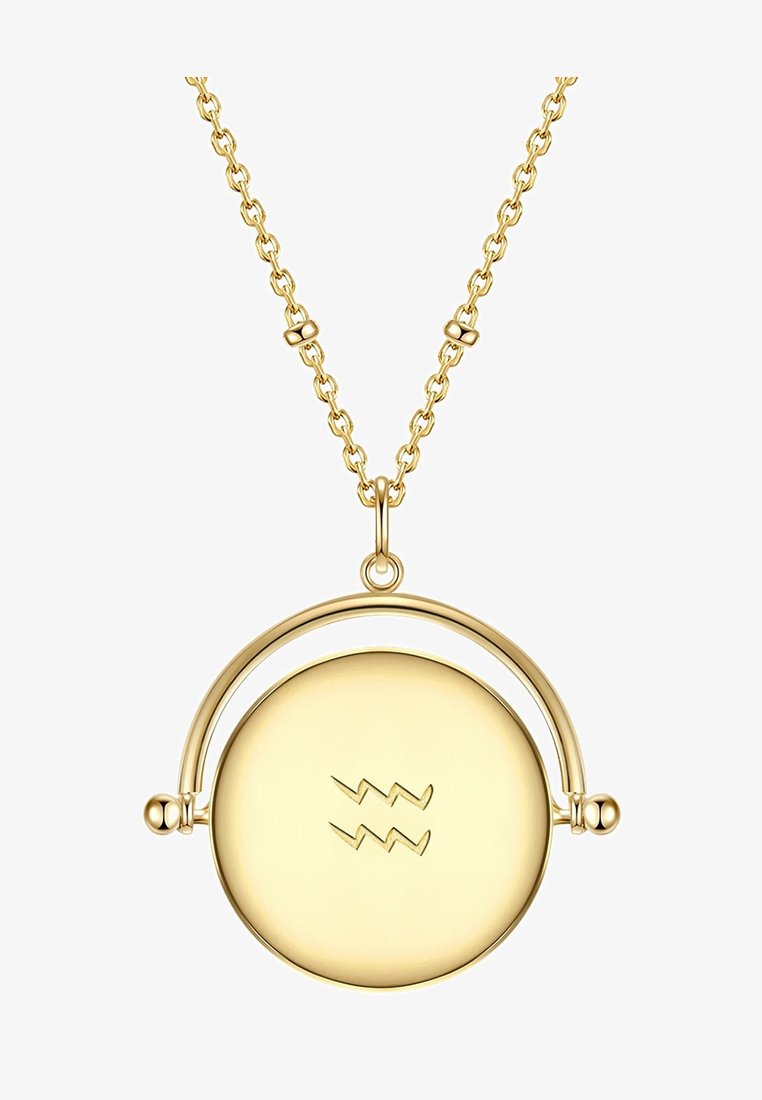 Collana d'oro con un pendente rotondo dal design curvo, inciso con un motivo a zigzag, su una catena delicata.