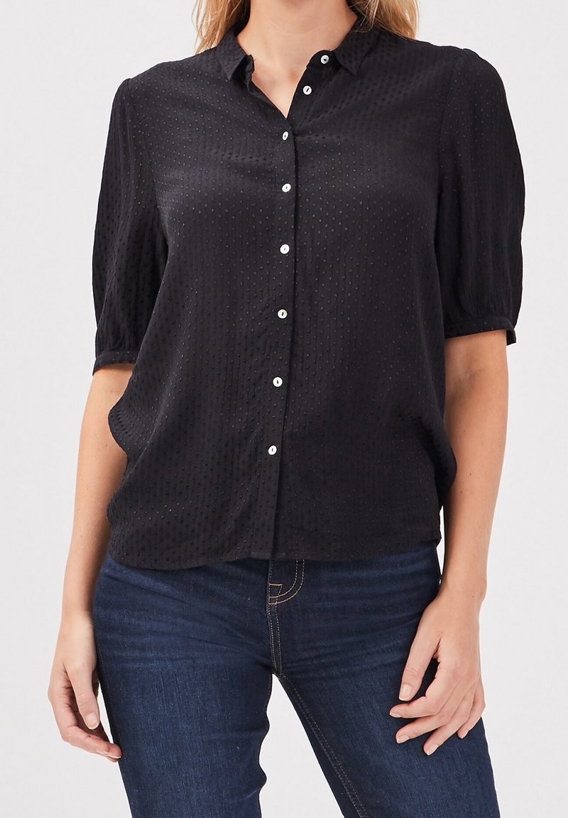 Black short-sleeve button-up shirt with a textured design and subtle dot pattern. Features a classic collar and clear buttons.
