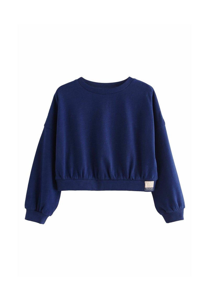 Sweatshirt court bleu marine à manches longues, ourlet et encolure côtelés, taille froncée et petite étiquette sur le côté inférieur.