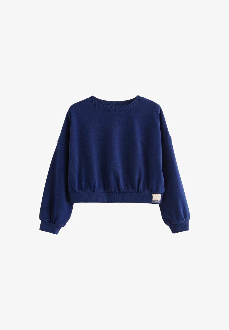 Felpa cropped blu navy con maniche lunghe, orlo e collo a coste, vita arricciata e una piccola etichetta sul lato inferiore.