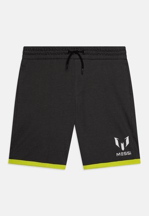 Sorte treningshorts med elastisk midje og snøring. Har sterke grønne detaljer i kanten og en hvit logo nederst til høyre.