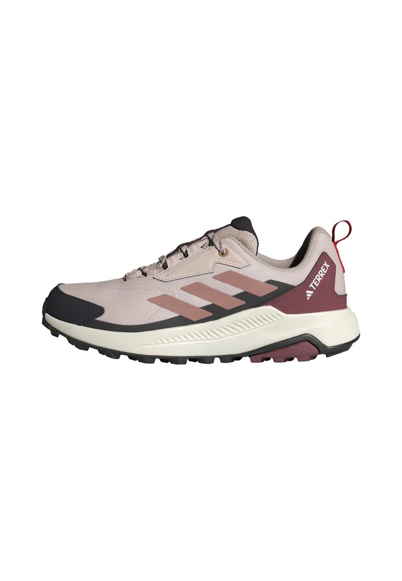 Light pink hiking shoe with a textured mesh upper, dark accents, and three stripes design. Features a rubber sole and red heel pull tab.
