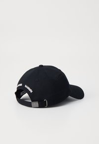 Black cotton baseball cap with a curved brim, adjustable strap, and white embroidered text on the back for brand identification.