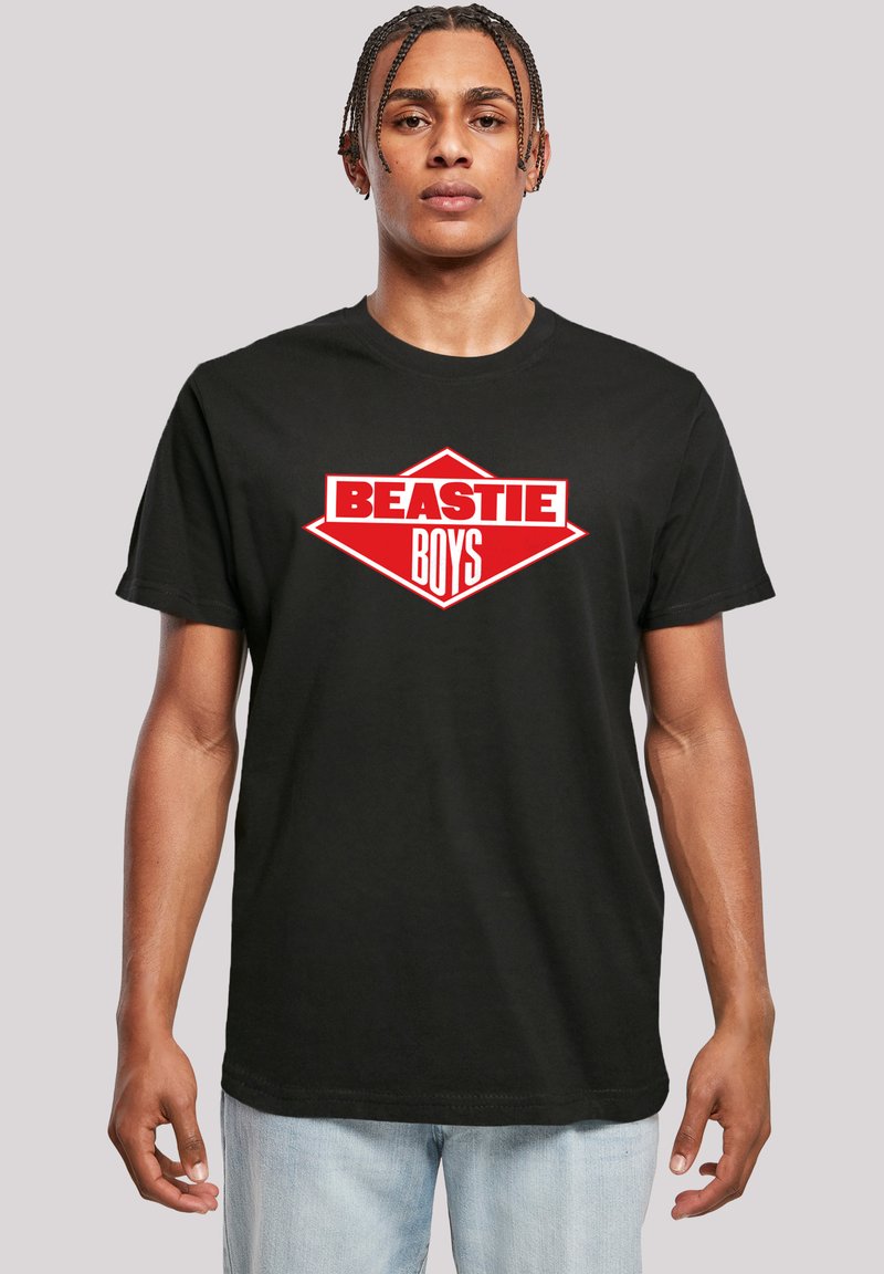 Black cotton t-shirt featuring a bold red and white "BEASTIE BOYS" logo in a diamond shape on the front. Short sleeves, crew neck design.
