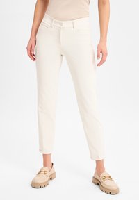 Witte op maat gemaakte broek met een strak ontwerp, gemaakt van een zachte, rekbare stof. Heeft een klassieke waistband en subtiele zakken aan de voorkant.