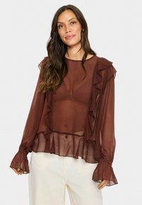 Maroon sheer blouse with ruffled accents, long sleeves with flared cuffs, and a layered hem. Lightweight, flowy fabric with a textured finish.