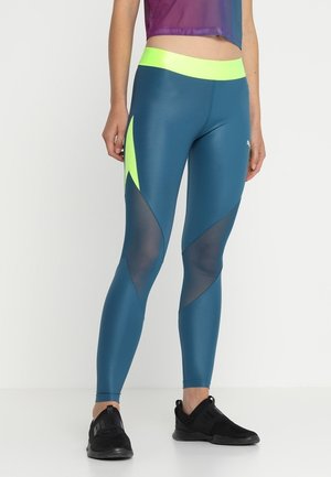 Leggings teal avec une haute taille jaune, comportant des panneaux en maille et des accents néon angulaires, conçus pour les vêtements de sport.