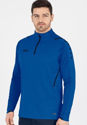 Blaue Langarmjacke mit Viertelreißverschluss, schwarzem Logo, strukturiertem Stoff und schwarzen Akzenten an den Schultern. Verfügt über runde Knopfdetails.