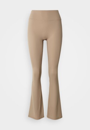 Beige legging met hoge taille en wijde pijpen, vervaardigd van gladde stof, plat uitgestald tegen een lichte achtergrond.