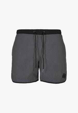 Grå simshorts i lättviktsmaterial, med svart dragsko i midjan, sidofickor och en liten logotyp på fållen.