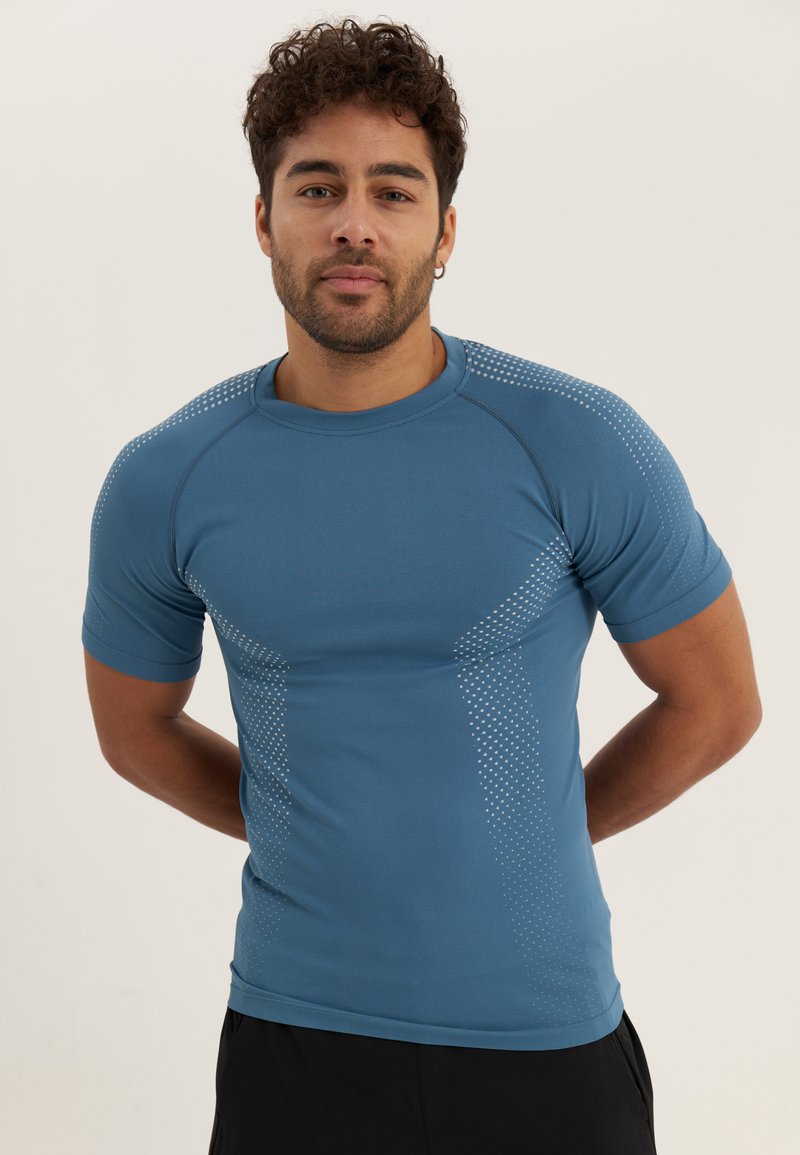 Blue athletic short-sleeve shirt with a fitted design, featuring dotted accents on the shoulders and sides, made from breathable material.