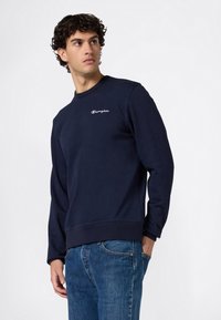 Sudadera azul marino de mezcla de algodón, con cuello redondo, puños acanalados y un pequeño logo blanco de Champion en el pecho.