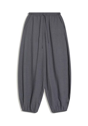Sive haremske hlače iz lahkega blaga z elastičnim pasom z vrvico, stranskimi žepi in zoženimi robovi.
