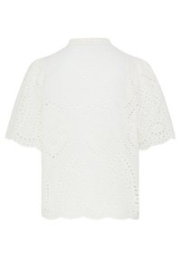 Chemisier blanc à manches courtes en tissu brodé ajouré, ourlet festonné et motif discret de découpes en forme de losange.