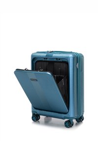 Tvrdý kufr v barvě modrozelené s žebrovanou strukturou, vybavený zipovým uzávěrem a otevřeným oddílem, odhalujícím černou látkovou výstelku a přepážky.