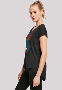 Black cotton t-shirt with a relaxed fit, short rolled sleeves, and a colorful graphic design on the front. Curved hemline detail.