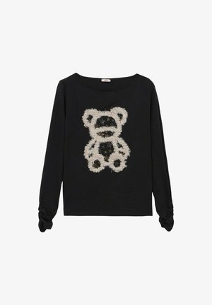 Top negro de manga larga con un diseño texturizado y esponjoso de un oso de peluche blanco con detalles en negro y escote redondo. Detalle fruncido en las mangas.