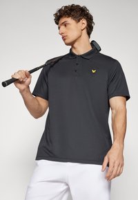 Dark gray polo shirt with a three-button placket, short sleeves, and a small yellow logo on the chest. Smooth fabric and relaxed fit.