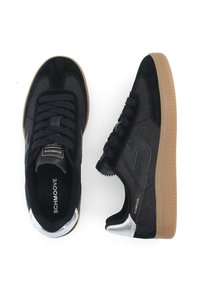 Black athletic shoes with a smooth textile upper, suede accents, silver heel detail, and gum rubber outsole. Features flat lace design.