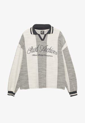 Pull à rayures grises et blanches avec un col en V, un col côtelé noir et des poignets. "Stwd Archives" brodé sur le devant en écriture noire.