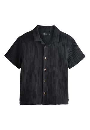 Chemise noire texturée à manches courtes avec col et cinq boutons beige sur le devant.