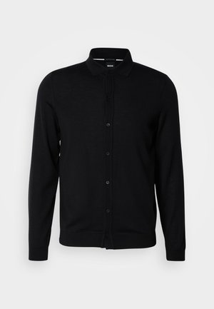 Cardigã preto de malha com gola, fecho frontal com botões, mangas longas e punhos canelados. Feito de um tecido suave.