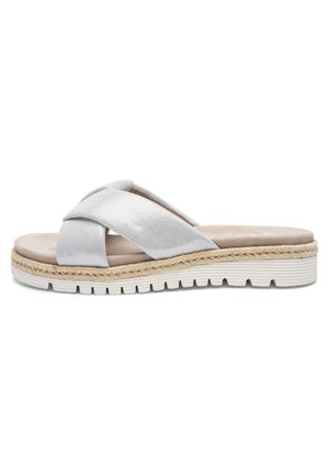 Silver crisscross fabric strap slide sandal with beige cushioned footbed and white textured rubber sole with woven jute trim.