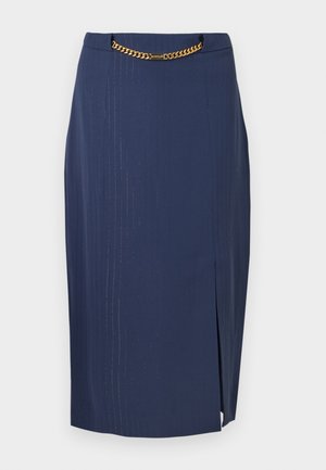 Navy pencil skirt with vertical pinstripes, featuring a gold chain accent at the waist and a slit on the right side for added detail.