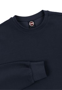 Navyblå ribbet langærmet skjorte med rund halsudskæring og Colmar Originals-mærke ved kraven.