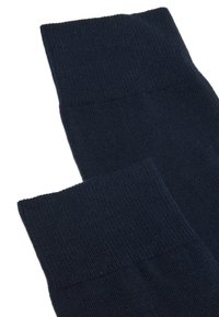 Calcetines de algodón azul marino con textura acanalada en la parte superior. La tela parece suave y elástica, con un acabado liso en todo momento.