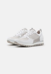 White and grey athletic shoes with mesh and suede panels, flat laces, a rounded toe, and a textured rubber sole for grip.