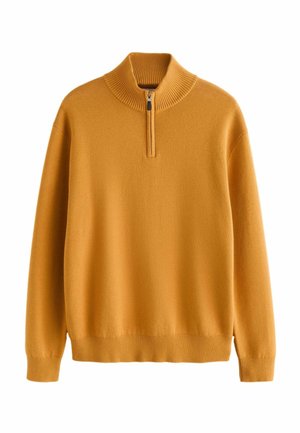 Oranž pullover-sviiter kõrge soonikkoes kraega, pool tõmblukuga sulgemine ning soonikkoes mansetid ja allserv. Pehme tekstuur ja vabalt voolav istuvus.