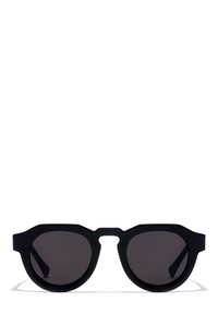 Schwarze Sonnenbrille mit runden Gläsern und geometrischem Rahmen. Aus mattem Kunststoff gefertigt, mit einem einzigartigen Brückenentwurf und dunkel getönten Gläsern.