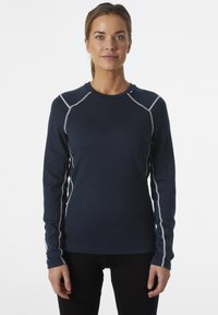 Granatowa bluzka z długim rękawem z okrągłym dekoltem, kontrastowym białym przeszyciem wzdłuż ramion i boków oraz miękkim, teksturowanym materiałem.