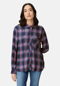 Long-sleeve plaid shirt in dark blue with red and light blue checks, button closure, collar, and single pocket on the chest. Soft fabric.