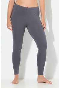 Leggings gris oscuro hechos de un material suave y elástico con un diseño ajustado y una cintura elástica. Sin costuras ni patrones visibles.