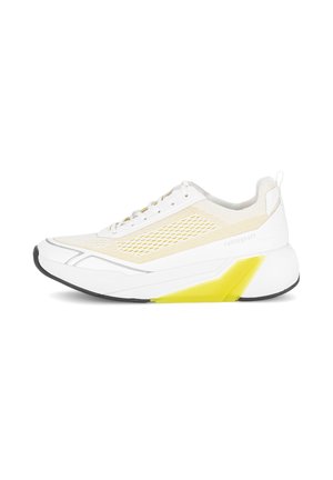 White sneaker with a mesh upper and rubber outsole; features a chunky sole with a yellow accent and lace-up closure.