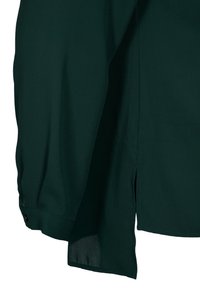 Chemise vert foncé à manches longues avec poignets boutonnés et détail fente latérale sur l'ourlet sur fond uni.