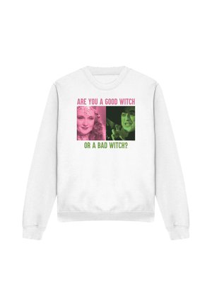 White sweatshirt with pink and green text "Are you a good witch or a bad witch?" and photos of a smiling woman and a snarling woman.