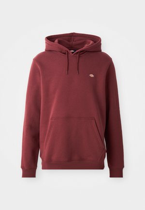 Maroon hooded sweatshirt made of soft fabric, featuring a kangaroo pocket, ribbed cuffs, and a small logo on the chest.