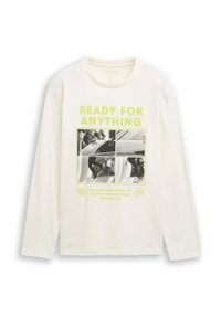 Vit långärmad skjorta med neongrön text "REDO FÖR ALLT" och ett svartvitt foto-rutnät med skateboardåkning på framsidan.