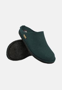 Green felt clogs with a smooth, rounded design, featuring a black textured sole and a small gold logo accent on the side.
