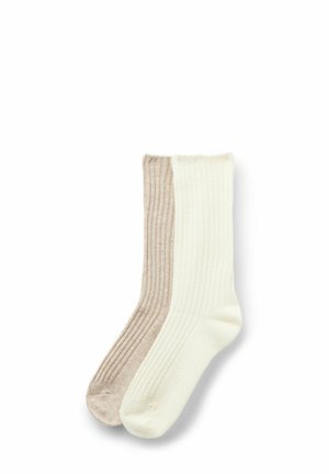 Rippensocken in zwei Tönen: hellbeige auf einer Seite und cremig auf der anderen. Weicher Stoff, normale Crew-Länge, nahtloses Zehendesign.