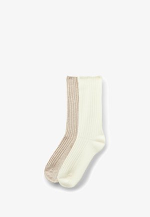 Calze a coste in due tonalità: beige chiaro da un lato e crema dall'altro. Texture morbida, lunghezza classica, design senza cuciture all'altezza delle dita.