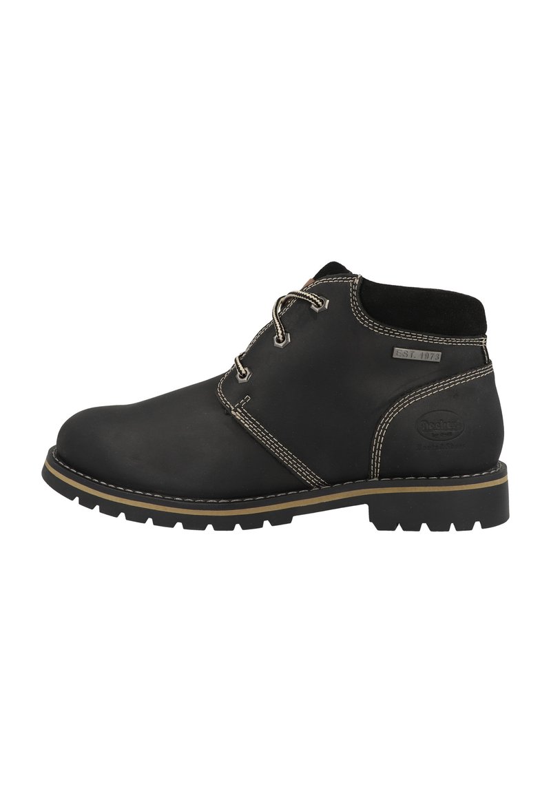 Black leather ankle boot with round toe, stitched accents, lace-up design, and rubber sole with a textured tread pattern.