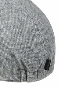 Gray fabric beret with a textured finish, featuring gathered details and a small brand tag at the seam.