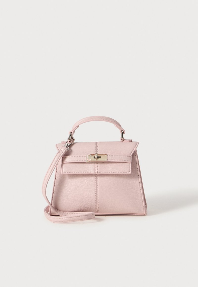 Small pink leather handbag with a structured design, top handle, detachable shoulder strap, and a silver clasp on the front.