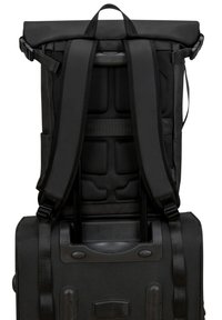 Black roll-top backpack with padded straps, textured mesh back, side pockets, and retractable handle for versatile carrying options.